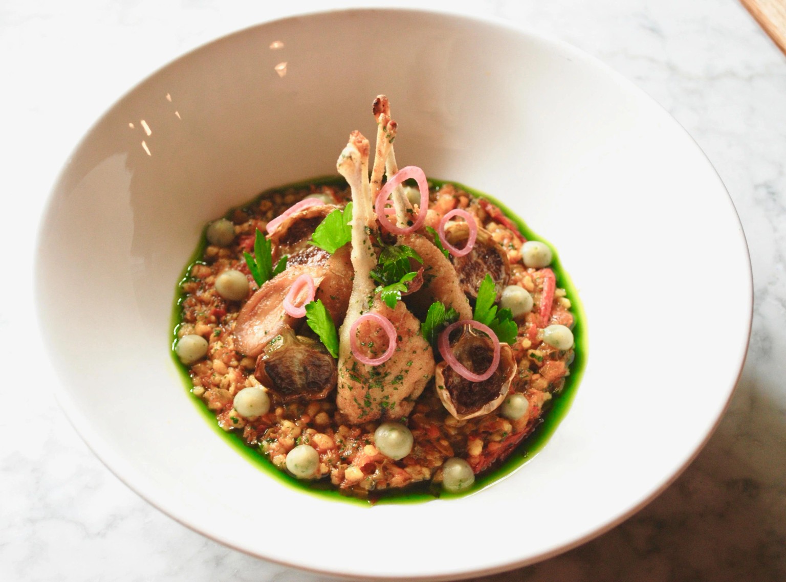 Frog legs, fregola, herbs and pickled shallot