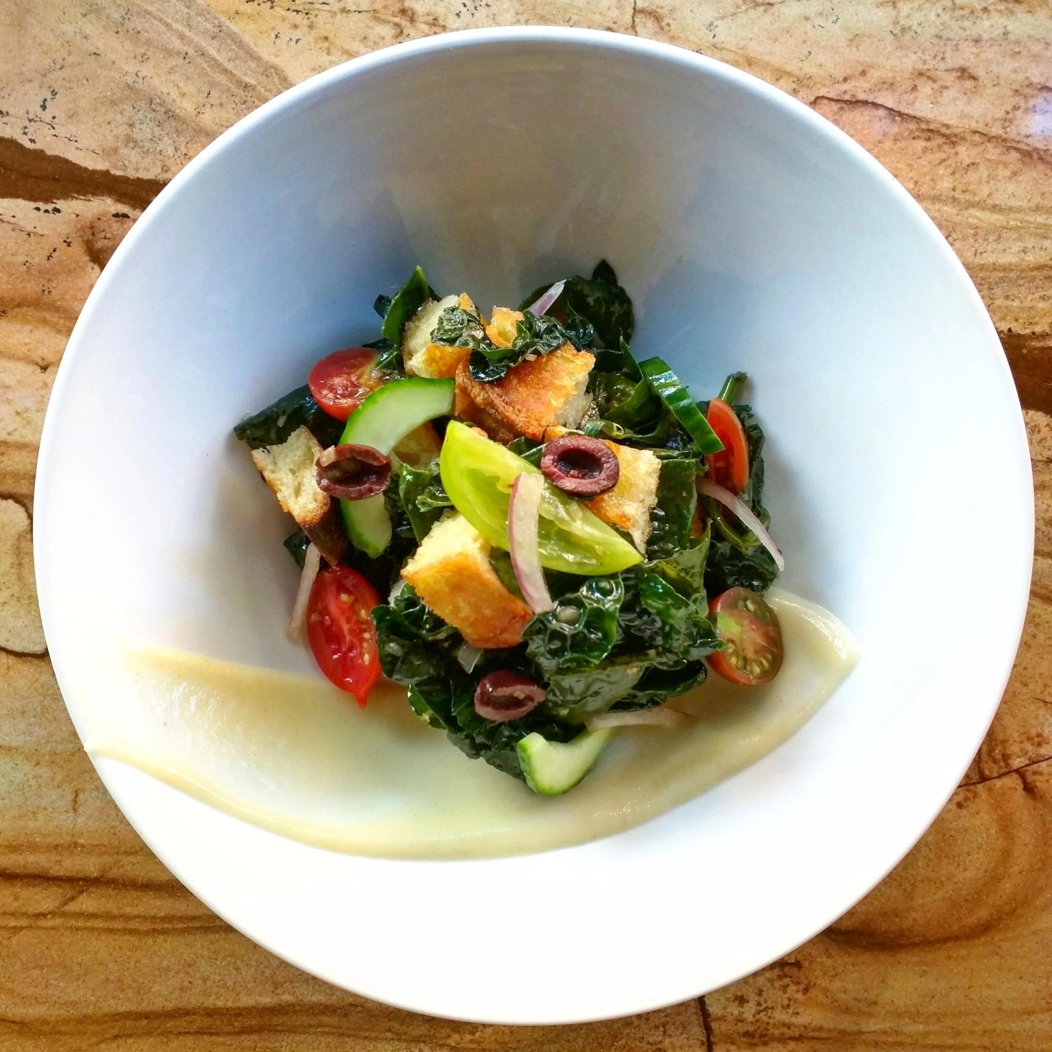 Kale panzanella, tomatoes, cucumber and olives